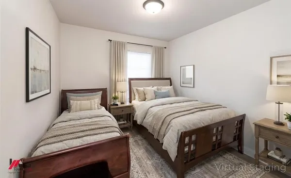 a bedroom with a bed a lamp and a window