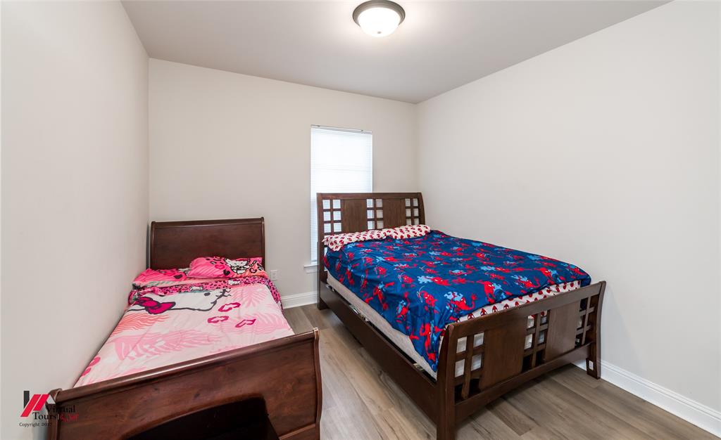 331 Hummingbird Lane Princeton, LA 71067 - Photo 27 of 34 Bedroom featuring wood finished floors and baseboards