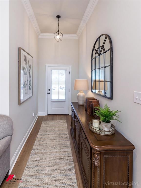 331 Hummingbird Lane Princeton, LA 71067 - Photo 3 of 34 AI Virtually added some staging. Entryway with ornamental molding and dark wood finished floors