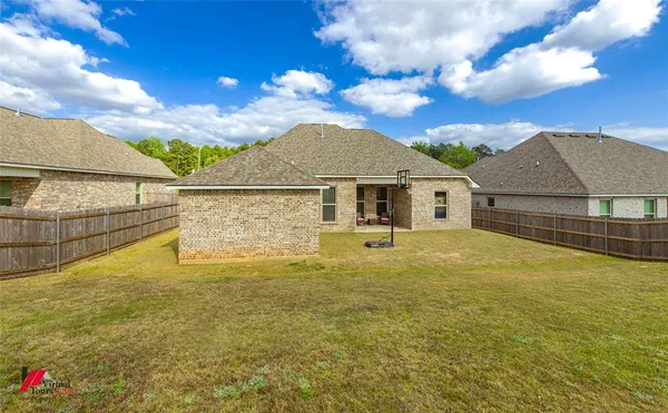 a view of a house with a backyard