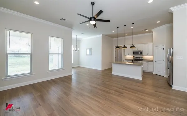 a living room with furniture kitchen and a window