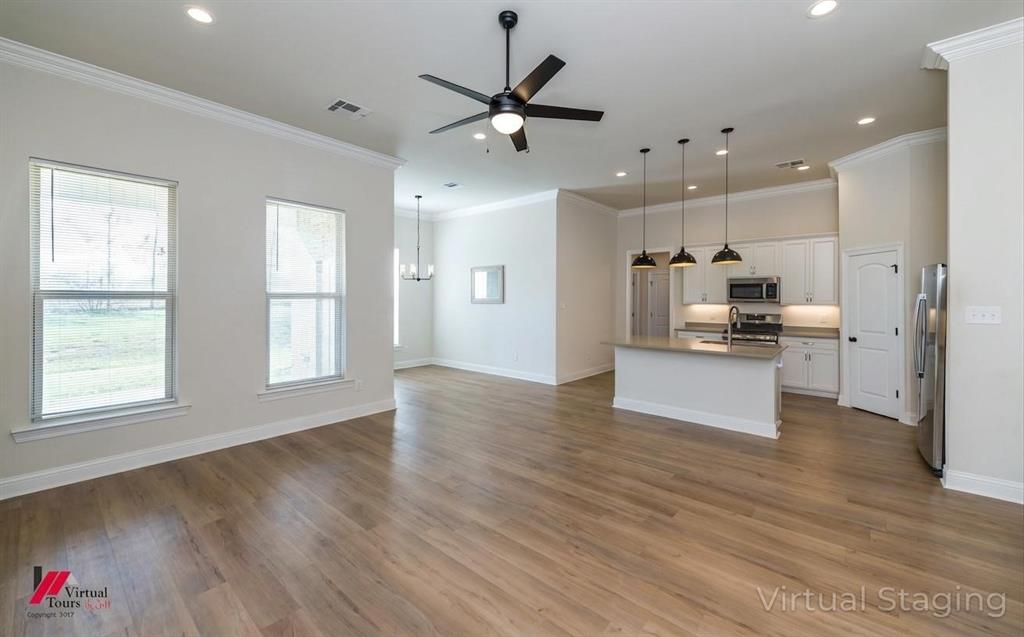 331 Hummingbird Lane Princeton, LA 71067 - Photo 8 of 34 AI Virtually removed furniture. Unfurnished living room with ceiling fan, dark wood-type flooring, hanging lights, and ornamental molding