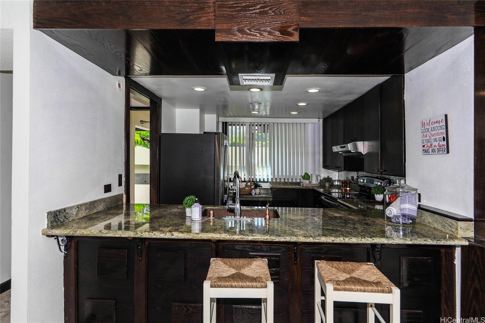 a kitchen with granite countertop a sink and cabinets