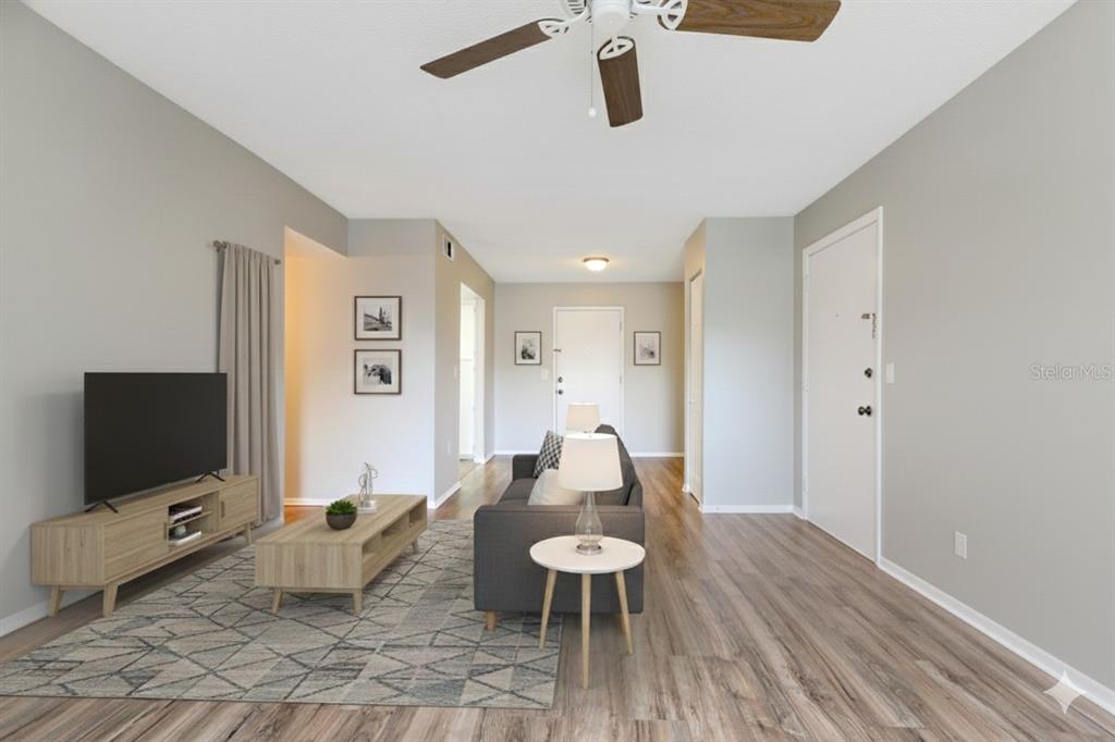 922 Lake Destiny Road, Unit E Altamonte Springs, FL 32714 - Photo 15 of 24 a living room with furniture and a flat screen tv