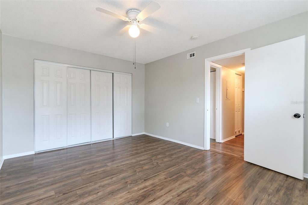 922 Lake Destiny Road, Unit E Altamonte Springs, FL 32714 - Photo 18 of 24 an empty room with wooden floor and ceiling fan