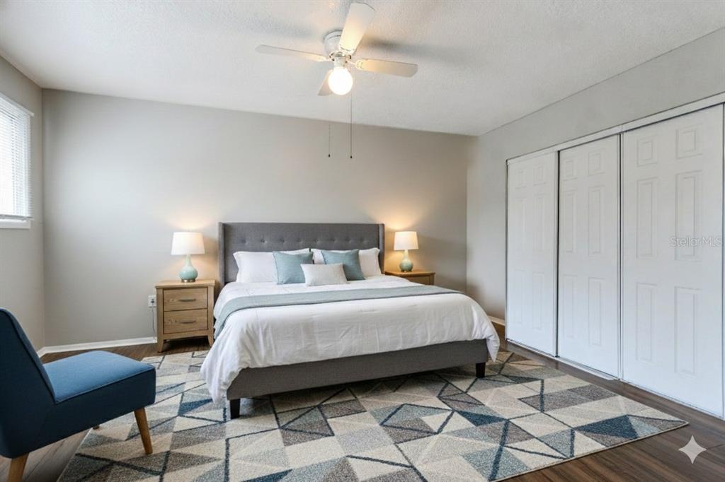 922 Lake Destiny Road, Unit E Altamonte Springs, FL 32714 - Photo 19 of 24 a bedroom with a bed a chair and potted plant on the dresser