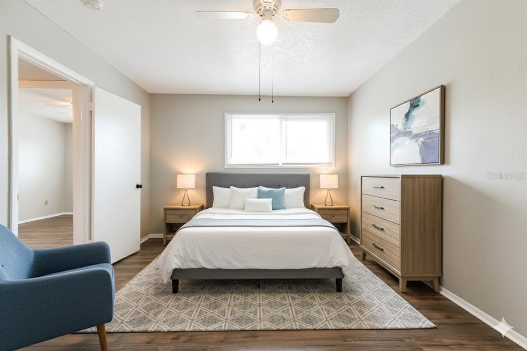 922 Lake Destiny Road, Unit E Altamonte Springs, FL 32714 - Photo 23 of 24 a spacious bedroom with a bed a couch and a window