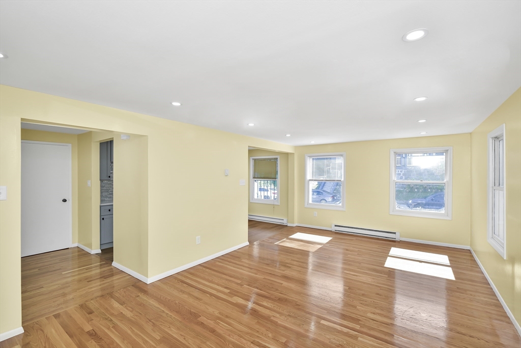 11 Greendale Road, Unit 2 Boston, MA 02126 - Photo 3 of 25 a view of an empty room with wooden floor and a window