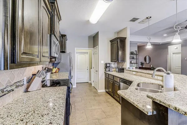 a large bathroom with a granite countertop sink a mirror and shower