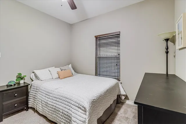 a bedroom with a bed and a potted plant