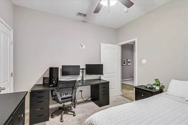 a bedroom with a bed and a desk