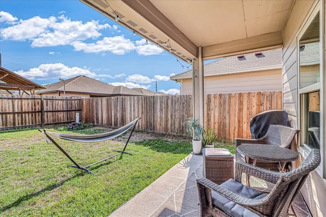 a view of a chair and table in backyard