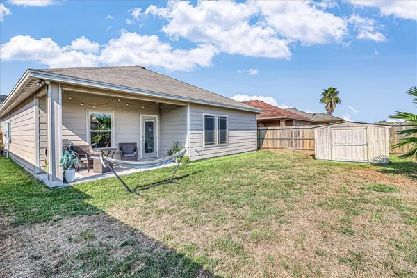 a view of a house with backyard and porch