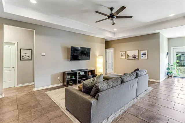 a living room with furniture and a flat screen tv with wooden floor