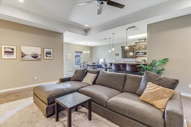 a living room with furniture and kitchen view