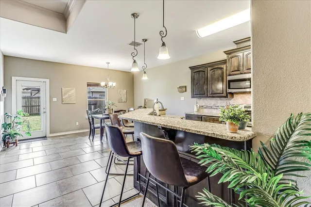 a large kitchen with a table and chairs in it