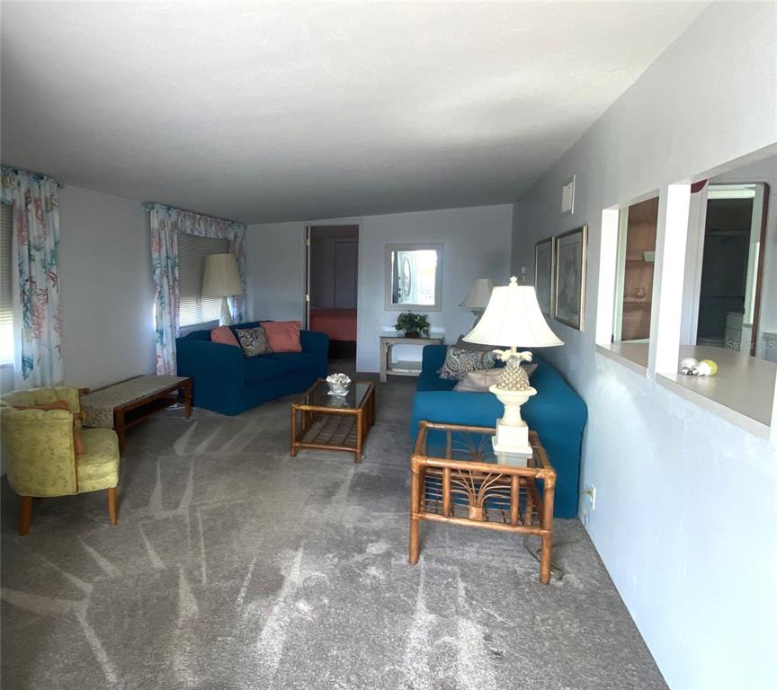 6618 Oregon Street Bradenton, FL 34207 - Photo 12 of 43 a living room with furniture a lamp and a table