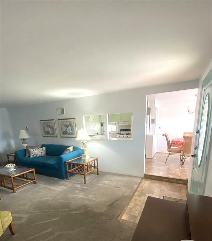 6618 Oregon Street Bradenton, FL 34207 - Photo 15 of 43 a living room with furniture and a table