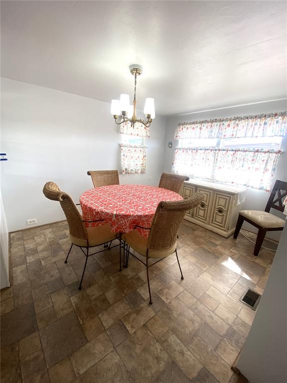 6618 Oregon Street Bradenton, FL 34207 - Photo 17 of 43 a dining room with furniture and window