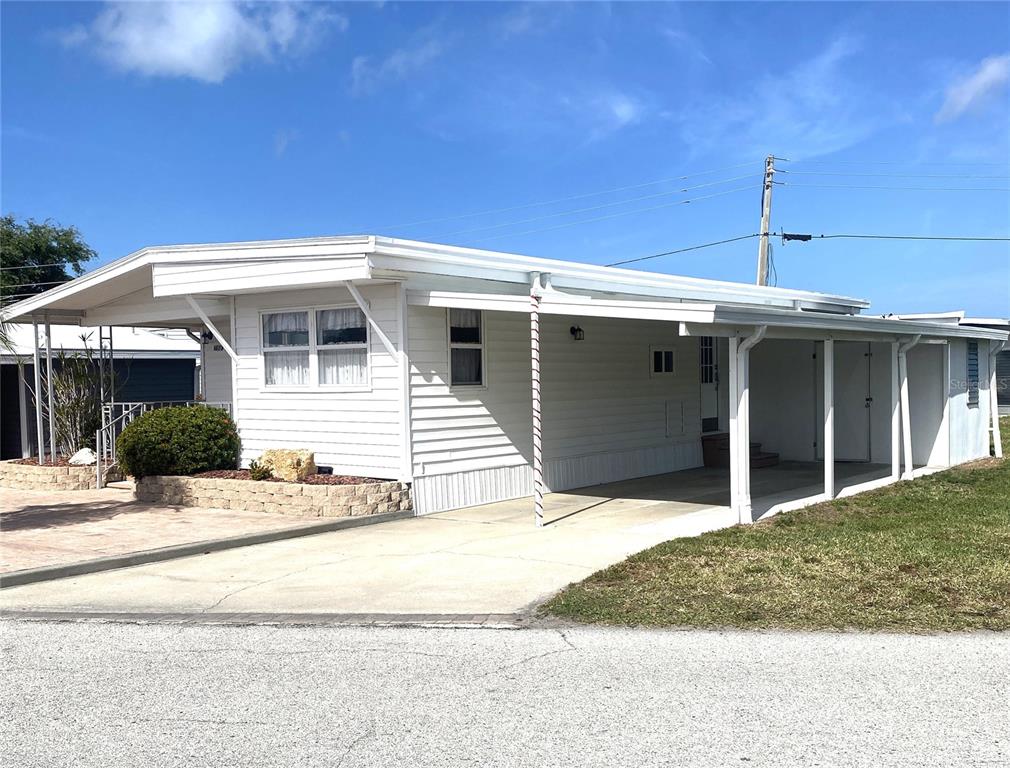 6618 Oregon Street Bradenton, FL 34207 - Photo 2 of 43 a front view of a house with a yard