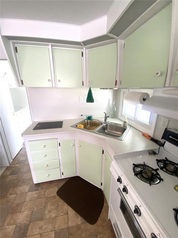 6618 Oregon Street Bradenton, FL 34207 - Photo 25 of 43 a kitchen with a sink stove and cabinets