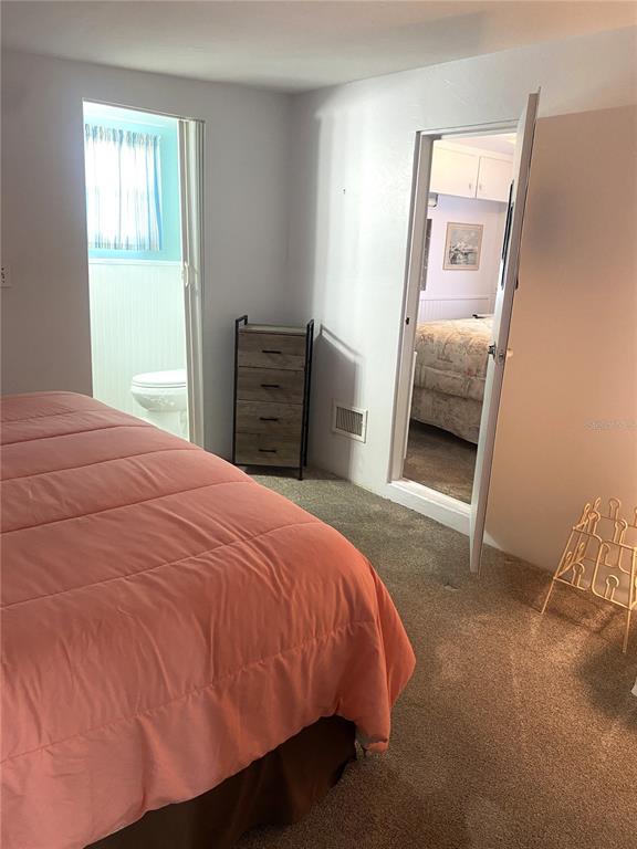 6618 Oregon Street Bradenton, FL 34207 - Photo 31 of 43 a bedroom with a bed and a mirror