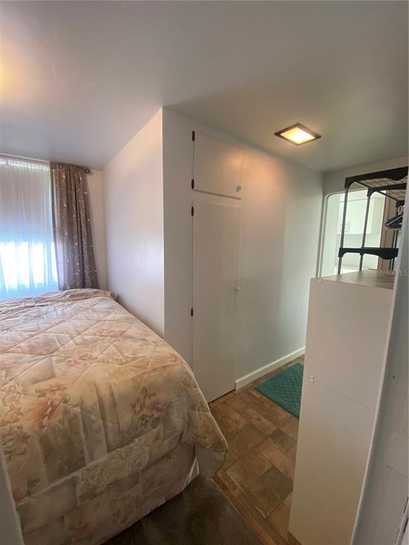 6618 Oregon Street Bradenton, FL 34207 - Photo 35 of 43 a bedroom with a bed and a dresser next to a window