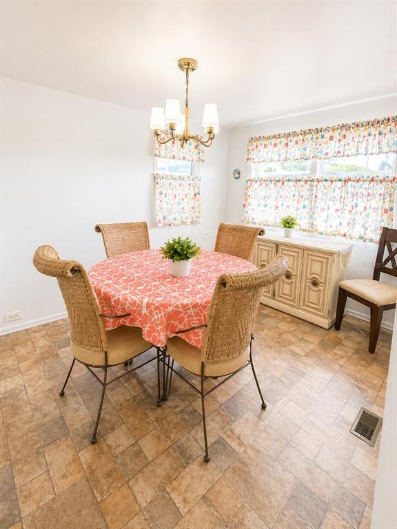 6618 Oregon Street Bradenton, FL 34207 - Photo 7 of 35 a view of a dining room with furniture and a window