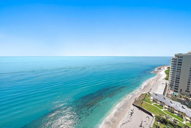a kitchen with granite countertop white cabinets and stainless steel appliances