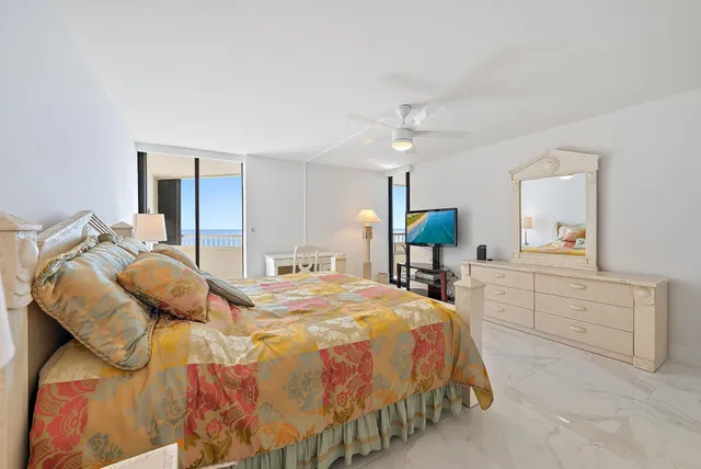 a spacious bedroom with a bed and a chandelier