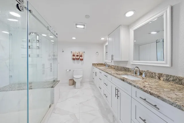 a bedroom with a bed a clock and a chandelier