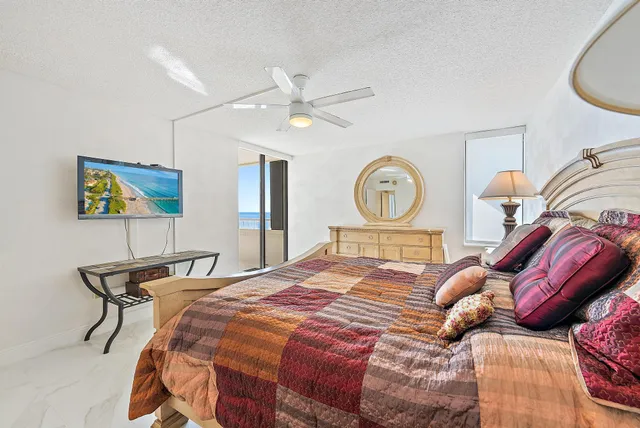 a bed room with a bed a dresser and a clock