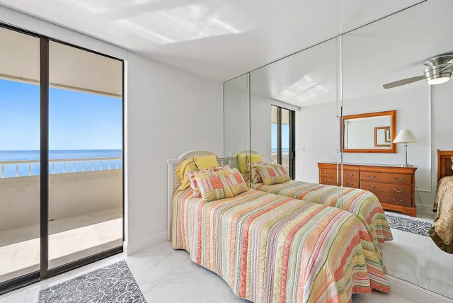 a bathroom with a granite countertop toilet sink and mirror