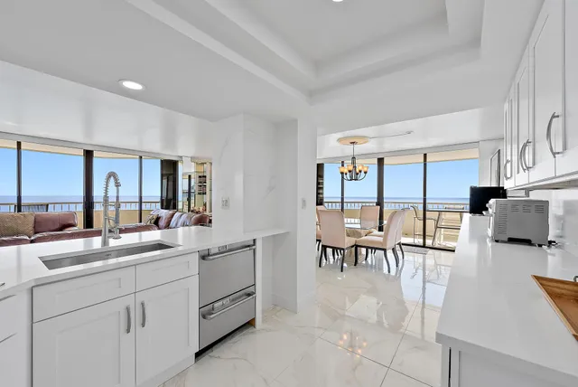 a kitchen with stainless steel appliances white cabinets and a refrigerator