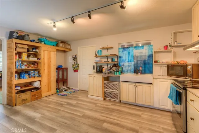 a kitchen with stainless steel appliances granite countertop a refrigerator and stove top oven