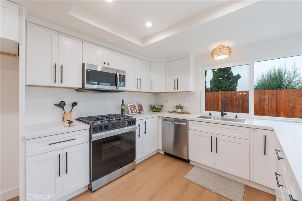 431 Devonshire Drive Brea, CA 92821 - Photo 11 of 45 a kitchen with white cabinets and appliances