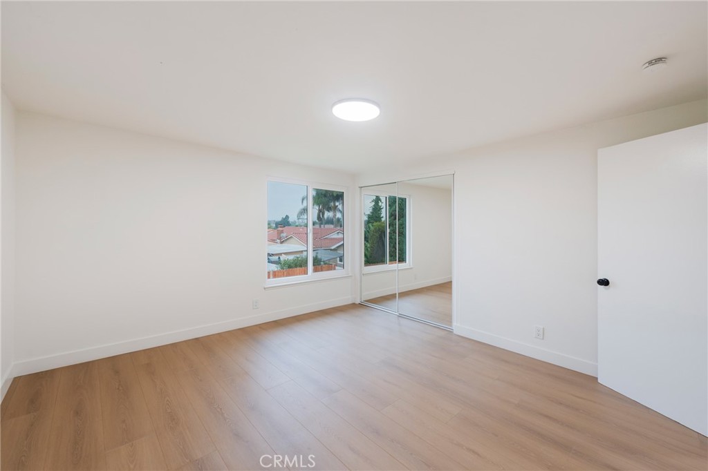 431 Devonshire Drive Brea, CA 92821 - Photo 32 of 45 a view of an empty room with wooden floor and a window