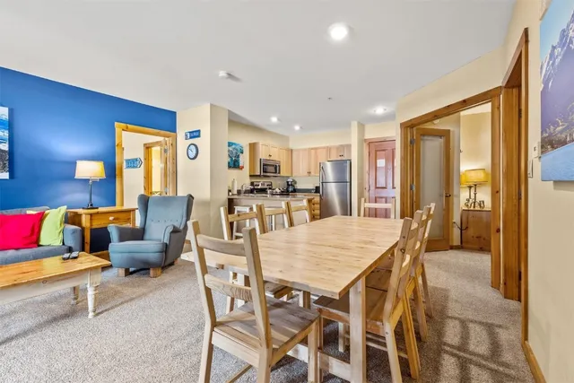 a view of a dining room with furniture and a large window