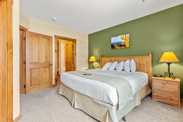 a bedroom with a bed and a lamp