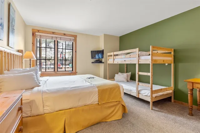 a bedroom with a bed and a mirror