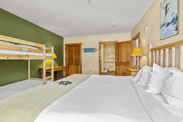 a bed room with a bed and a chair