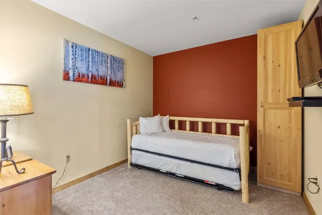 a bedroom with a bed and a wall painting