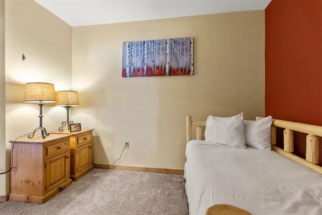 a bedroom with a bed and lamp