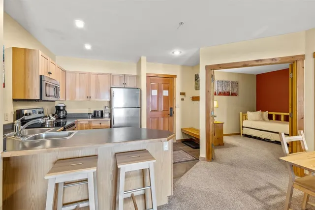 a kitchen with stainless steel appliances granite countertop a refrigerator and a sink
