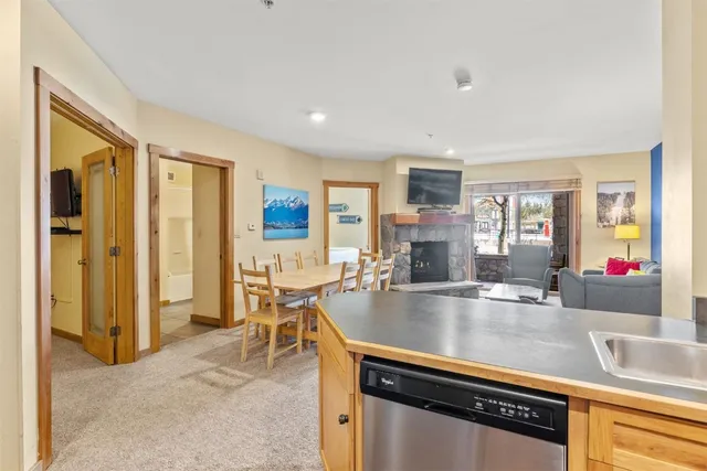 a living room with stainless steel appliances granite countertop furniture and a kitchen view