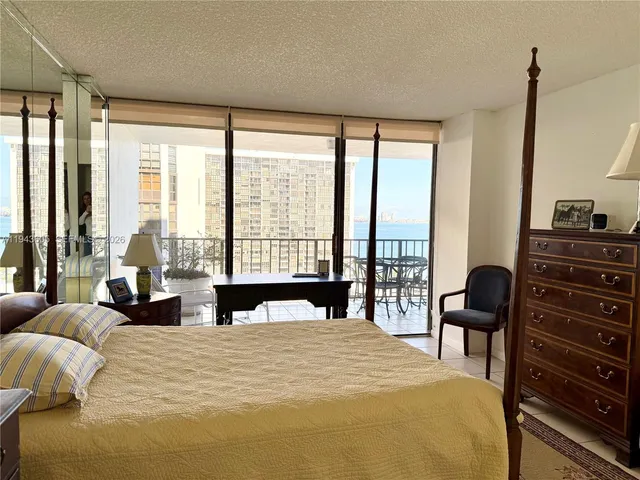 a bedroom with a large bed and a large window