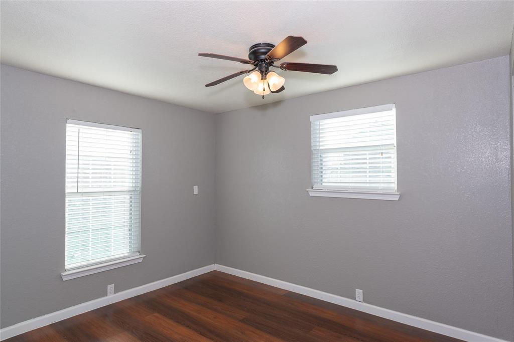 4405 Ray White Road, Unit A Fort Worth, TX 76244 - Photo 11 of 20 a view of an empty room with wooden floor and a window