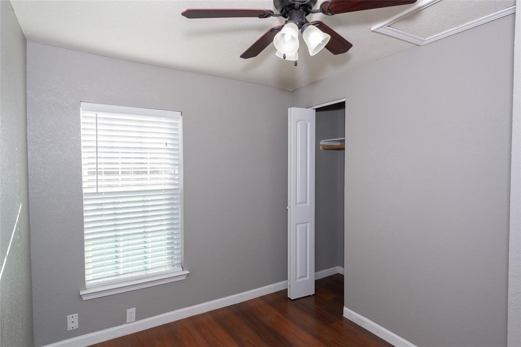 4405 Ray White Road, Unit A Fort Worth, TX 76244 - Photo 15 of 20 a view of an empty room with wooden floor and a window