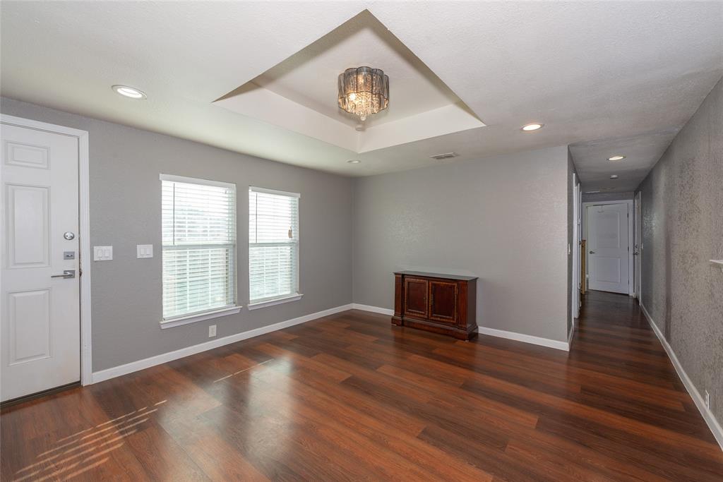4405 Ray White Road, Unit A Fort Worth, TX 76244 - Photo 5 of 20 an empty room with wooden floor and windows