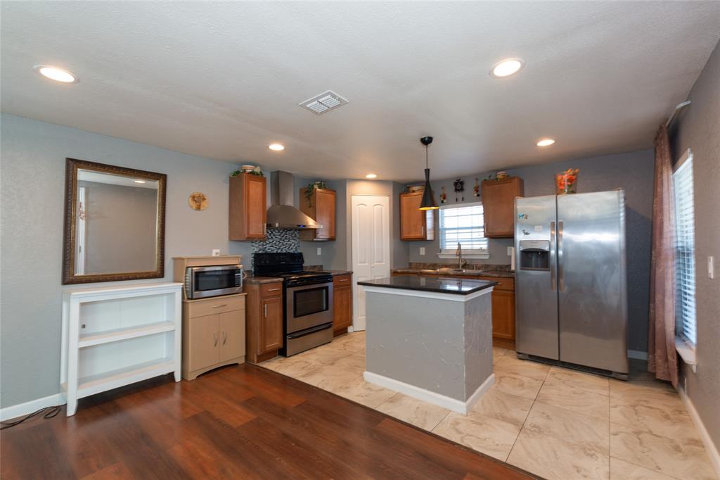 4405 Ray White Road, Unit A Fort Worth, TX 76244 - Photo 6 of 20 a kitchen with granite countertop a refrigerator and a stove top oven